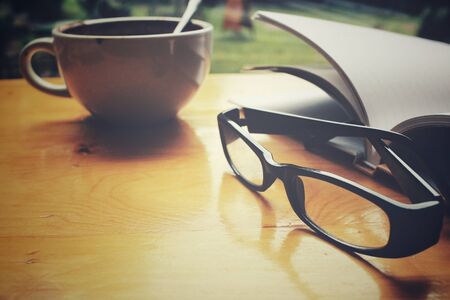 Book and glasses with coffee cupの写真素材