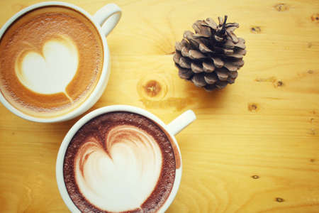 Vintage latte art coffee with hot chocolateの写真素材