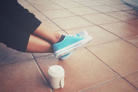 Coffee paper cup with sneakersの写真素材