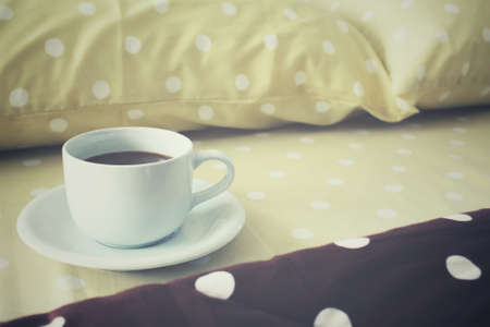 Coffee cup on the bedの写真素材