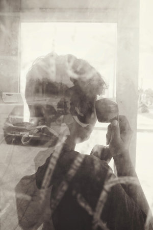 Double exposure of woman talking on telephone with road
