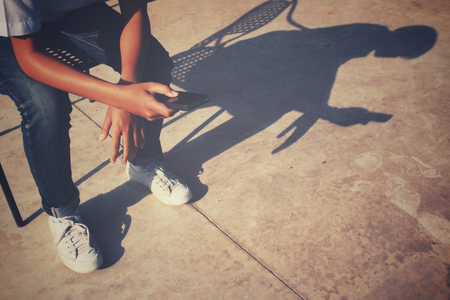 Using smart phone on the chair with shadowの写真素材