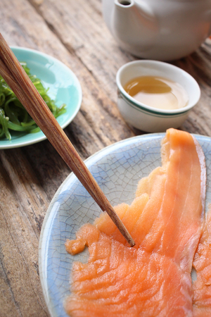 Smoked salmon and seaweed salad with hot teaの写真素材