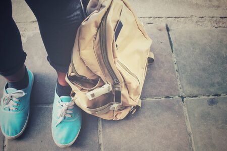Selfie of woman tourist with a backpack standing on roadの写真素材