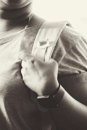 Woman tourist with a backpack standing on roadの写真素材