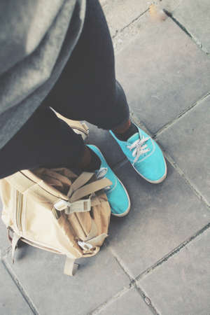 Selfie of woman tourist with a backpack standing on roadの写真素材