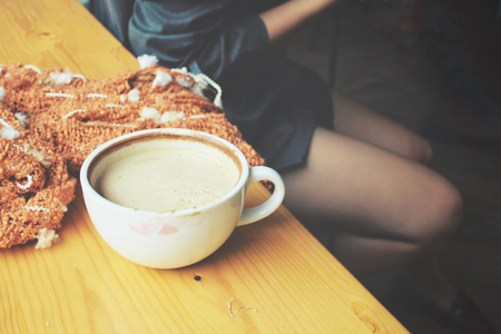 Woman drink coffee with smartphone and scartの写真素材
