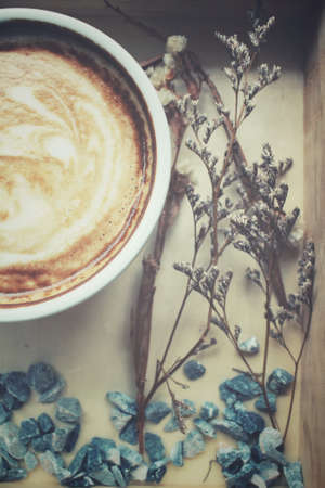 Vintage latte coffee with dried flowersの写真素材