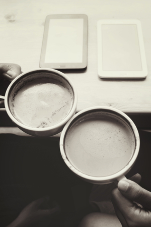 Male and female couple with latte coffee and roseの写真素材