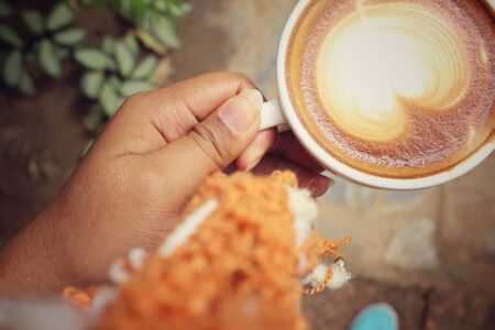 Selfie of hand with drinking coffee cupの写真素材
