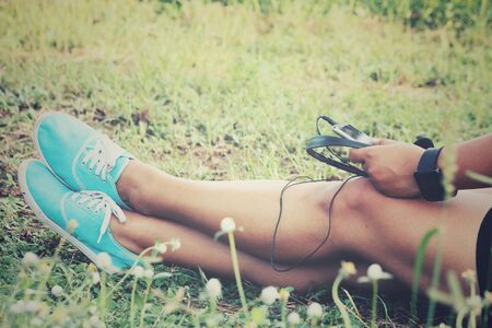 Woman listening to music on earphone with smart phoneの写真素材