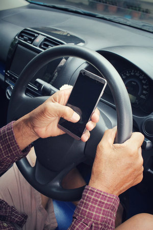 Man using smart phone in the car.