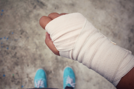 Selfie of bandage hand with shoesの写真素材