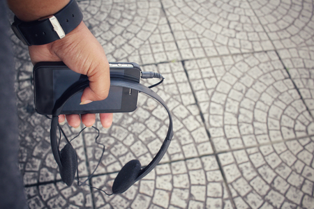 Woman listening to music on earphone with smart phoneの写真素材