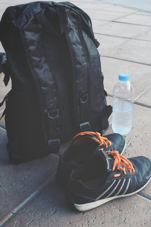 Shoes with a backpack and water drinkの写真素材