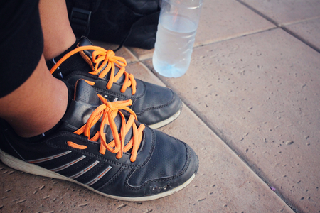 Selfie of shoes with a backpack and water drinkの写真素材