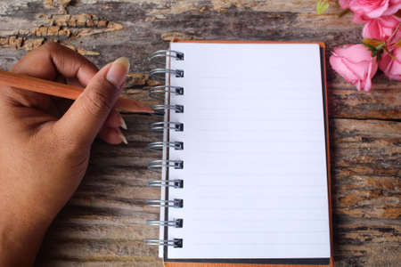 Woman with pen writing on paperの写真素材