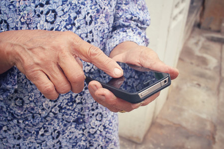Senior using smart phone on the road