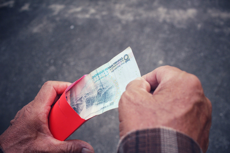 Red envelope on hands in chinese new year festivalの写真素材