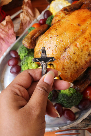 Roasted turkey with vegetables and cross for thanksgiving dayの写真素材