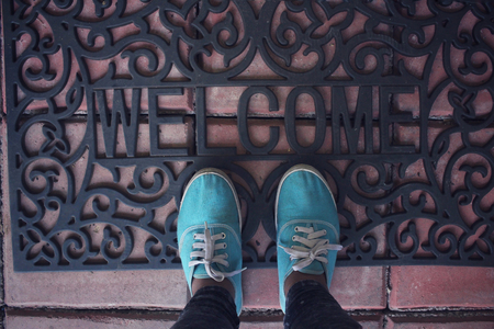Selfie of sneakers with welcome doormatの写真素材