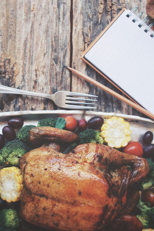 Roasted turkey chicken with blank notepad  for thanksgiving dayの写真素材