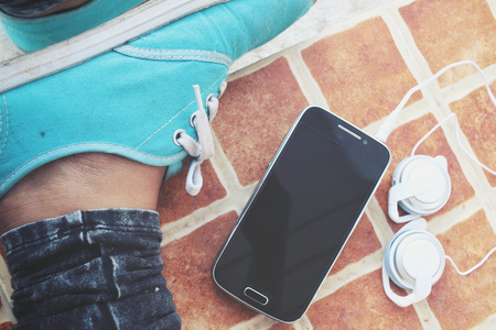 Selfie of sneakers with earphone and smart phoneの写真素材
