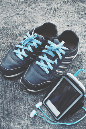 Sport shoes with smart phone armband and earphoneの写真素材