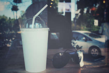 Iced coffee with smart phone and sunglass at cafeの写真素材