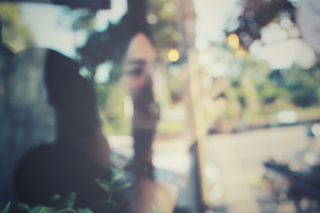 Woman using a camera to take photo at cafeの写真素材