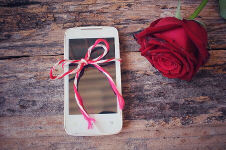 Red roses with smart phoneの写真素材