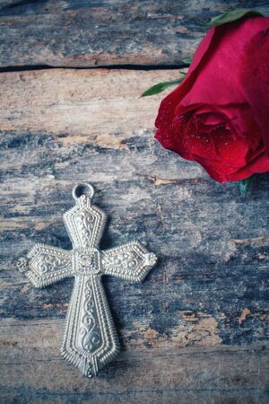 Red roses with crossの写真素材