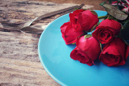 Red roses with spoon and forkの写真素材
