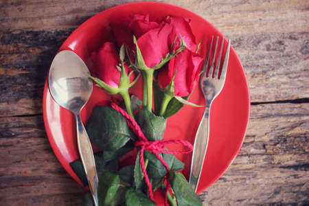 Red roses with spoon and forkの写真素材