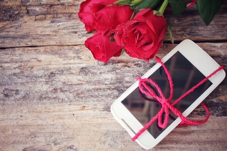 Red roses with smart phoneの写真素材