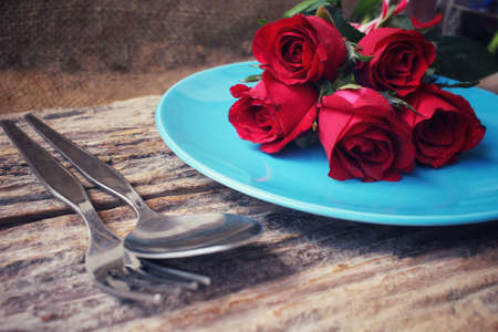 Red roses with spoon and forkの写真素材