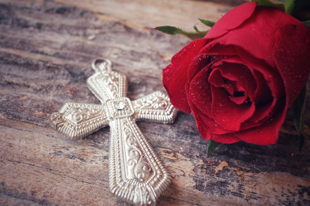 Red roses with crossの写真素材