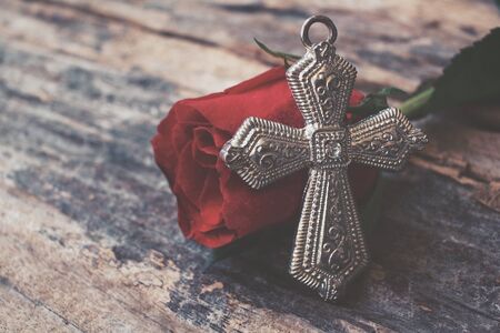 Red roses with crossの写真素材