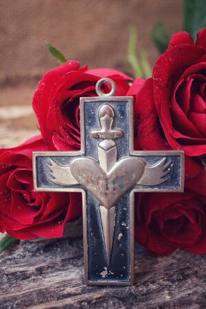 Red roses with crossの写真素材