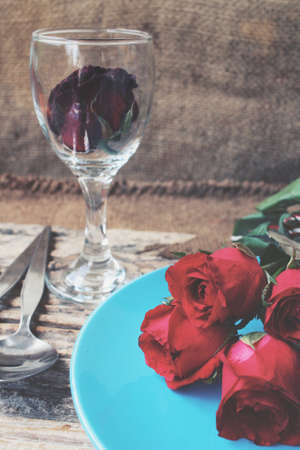 Red roses with spoon and forkの写真素材