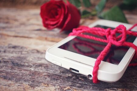 Red roses with smart phoneの写真素材