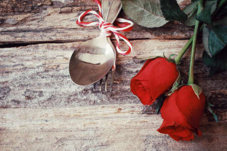 Red roses with spoon and forkの写真素材