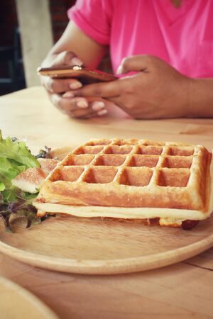 Belgium waffles with smart phoneの写真素材