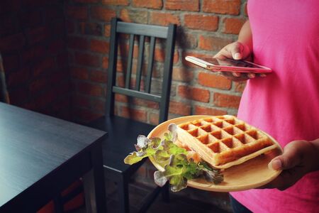 Belgium waffles with smart phoneの写真素材