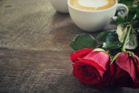 Two cups of latte art coffee with red roseの写真素材