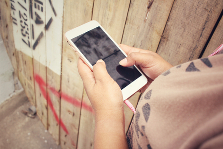 Woman listening to music on earphone with smart phoneの写真素材