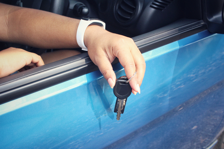 Woman with key car on handの写真素材