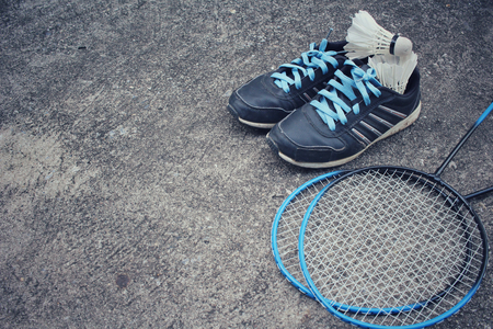 Sport shoes with shuttlecocks and badminton racket.の写真素材