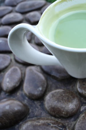 Green tea and milk on cupの写真素材