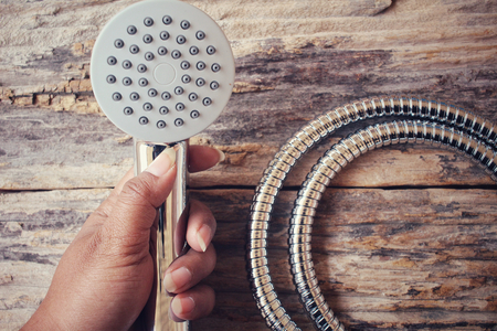Shower head on wood backgroundの写真素材